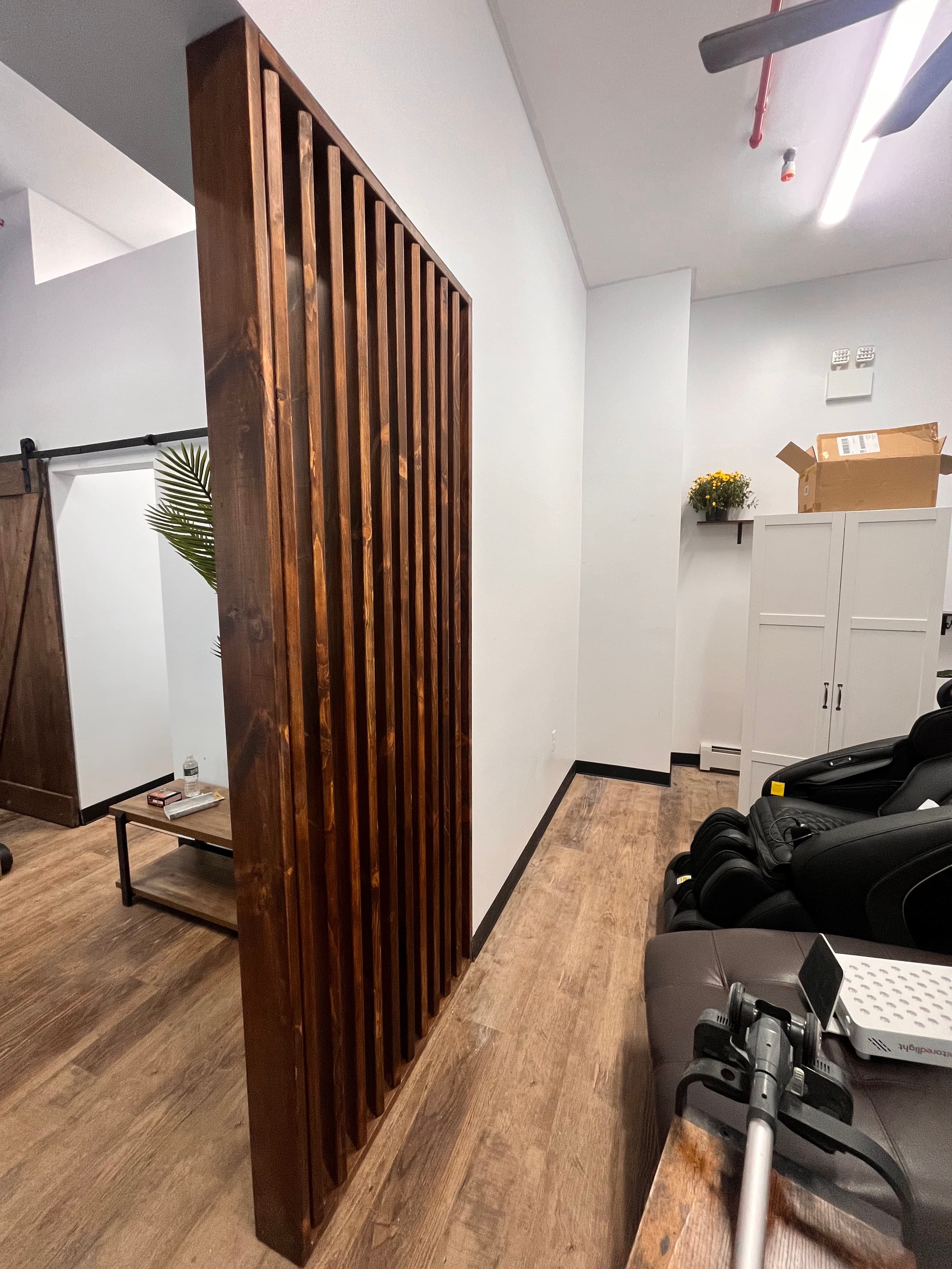 Vita Wellness Center Relocation — Unit 1 & Unit 2 — Custom Andor Willow stained-wood slat divider wall in the Vita Wellness Center